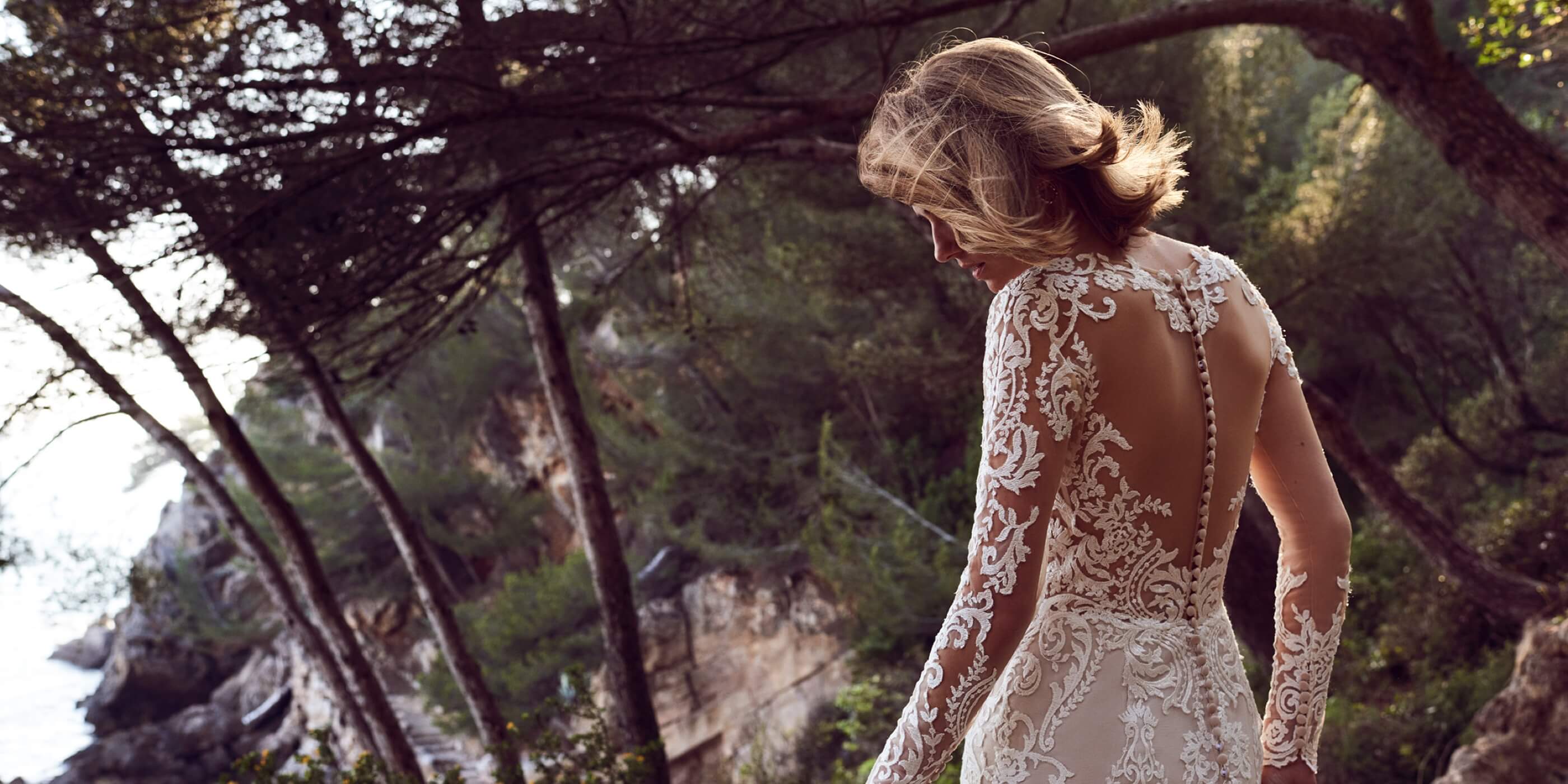 Model wearing lace long sleeve wedding dress
